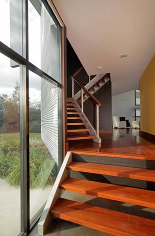 Despite its slender apparel, the house exudes a robust build that speaks of durability and practicality. The thermal chimney folds neatly into the stairwell cavity to help circulate fresh air throughout the house.